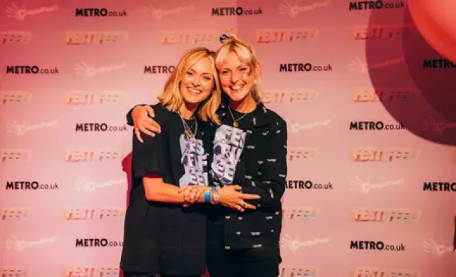 Two white women hugging and smiling to camera. The women photographer are our Founder Kris and Patron Fearne Cotton