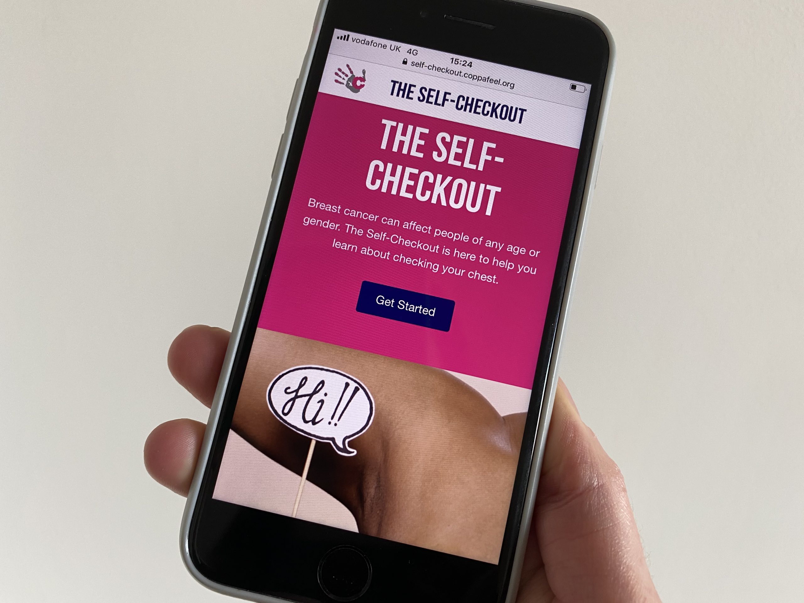 A hand holding an Iphone using the CoppaFeel! self checkout checking tool