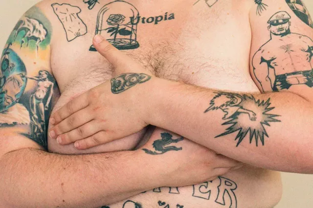 A person who is tattooed cradling their chest | CoppaFeel! | Breast cancer awareness