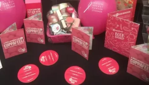 An awareness table with a selection of coppaFeel! awareness materials including checking leaflets and boob coasters