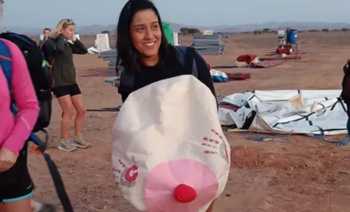 A woman pictured in the desert completing one of our CoppaTreks wearing a boob suit