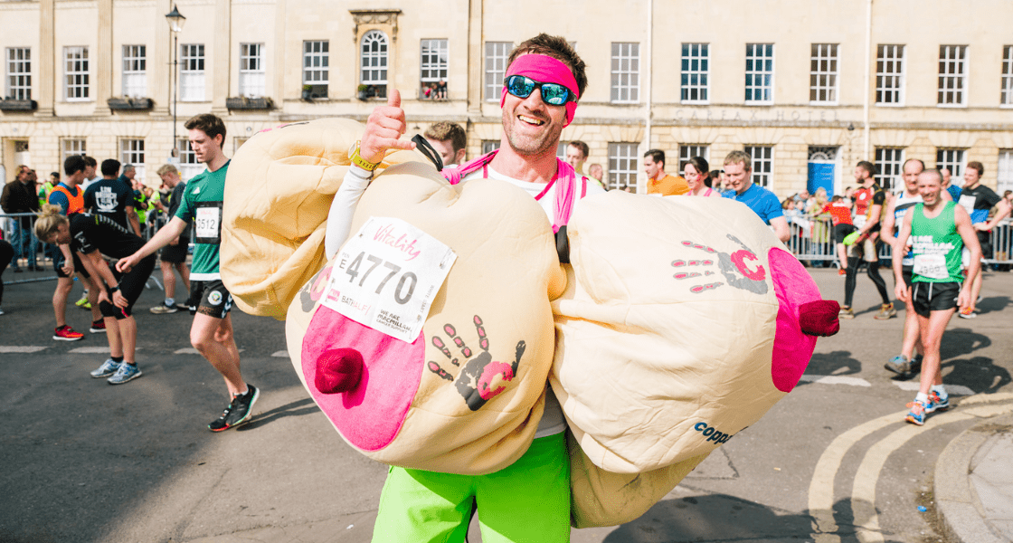 A man wearing 3 boob suits whilst taking part in a running challenge for CoppaFeel!