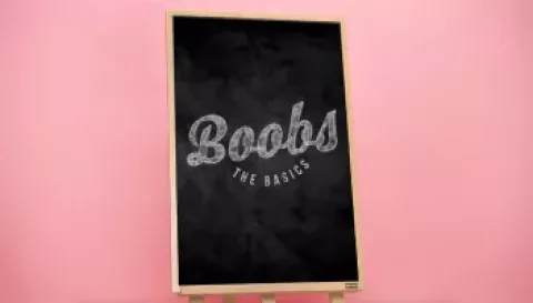 A blackboard that has the words 'boobs the basics' written in white chalk | CoppaFeel!