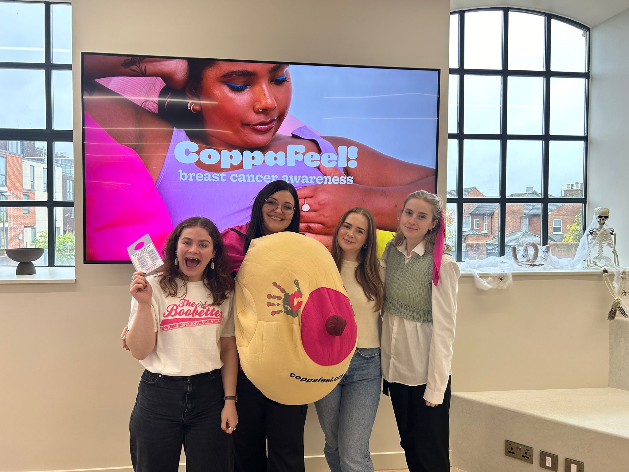 A group of young volunteers giving a CoppaFeel! presentation